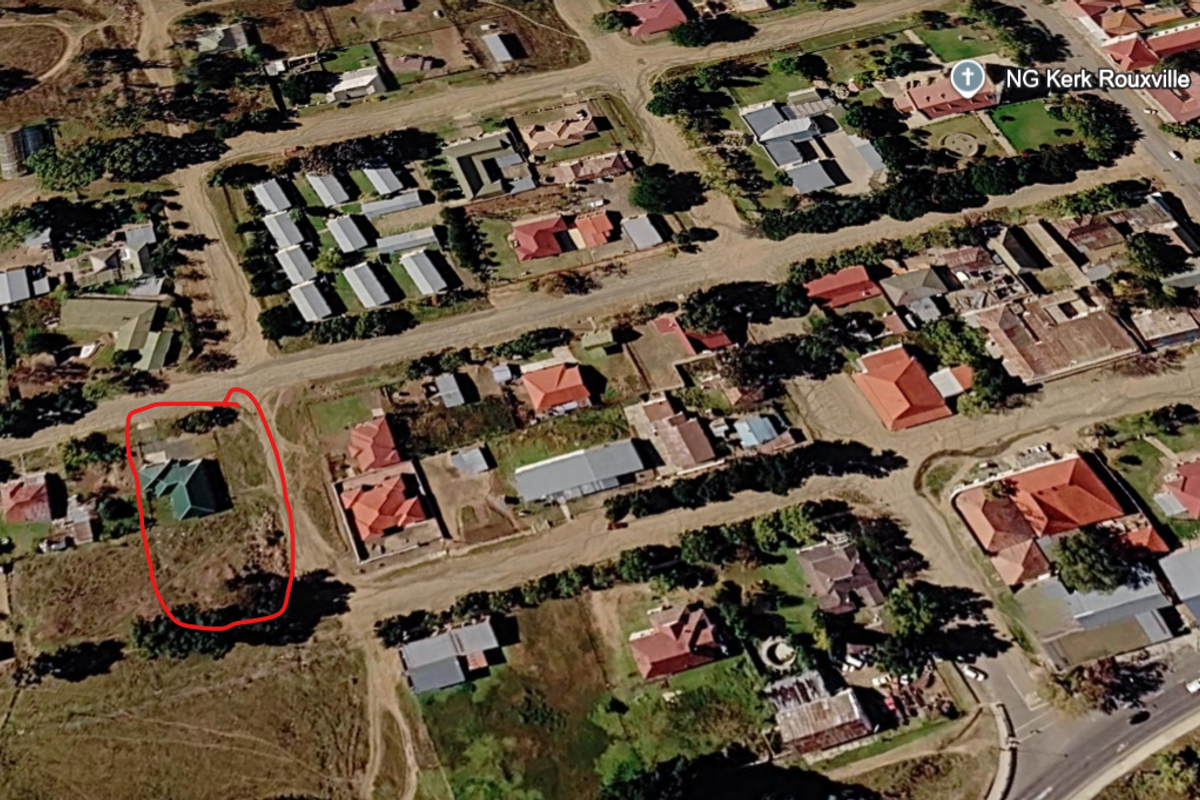 Aerial view of a residential plot in a suburban neighborhood, highlighting the property boundaries and surrounding street layout.