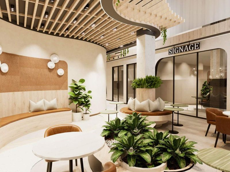 Modern office lobby featuring a slatted timber ceiling, curved built-in bench seating, and glass-partitioned office suites with contemporary finishes.