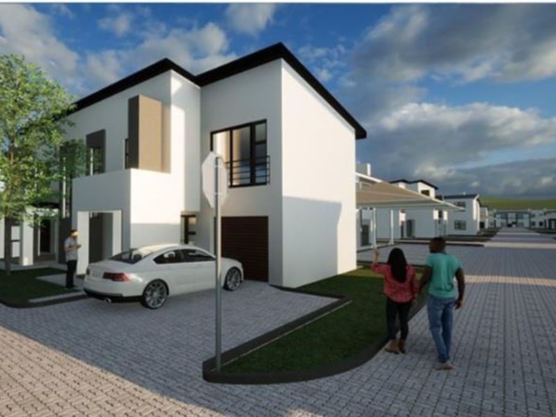 A modern residential house exterior featuring a paved driveway, garage, and contemporary architectural design within a planned estate setting.