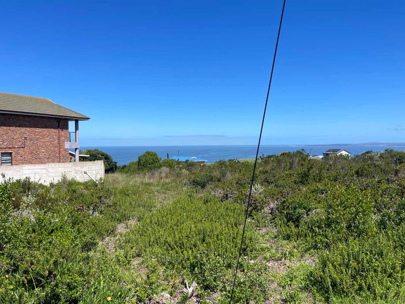A scenic view of the ocean and coastline from the vacant residential land, showcasing the natural landscape and surrounding area.