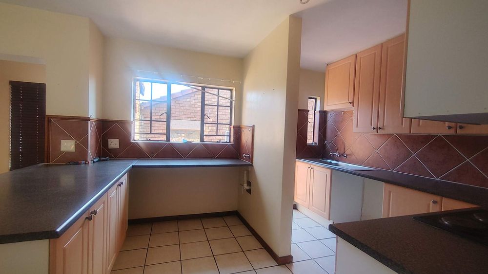 Neat, spacious kitchen with separate scullery