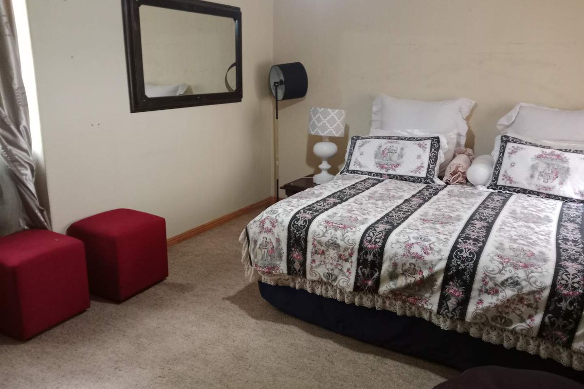 A bedroom featuring carpeted flooring and neutral wall tones, providing a functional space for rest.