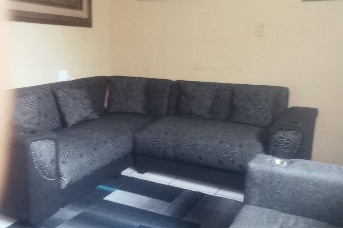 A living room area featuring tiled flooring and neutral wall finishes.