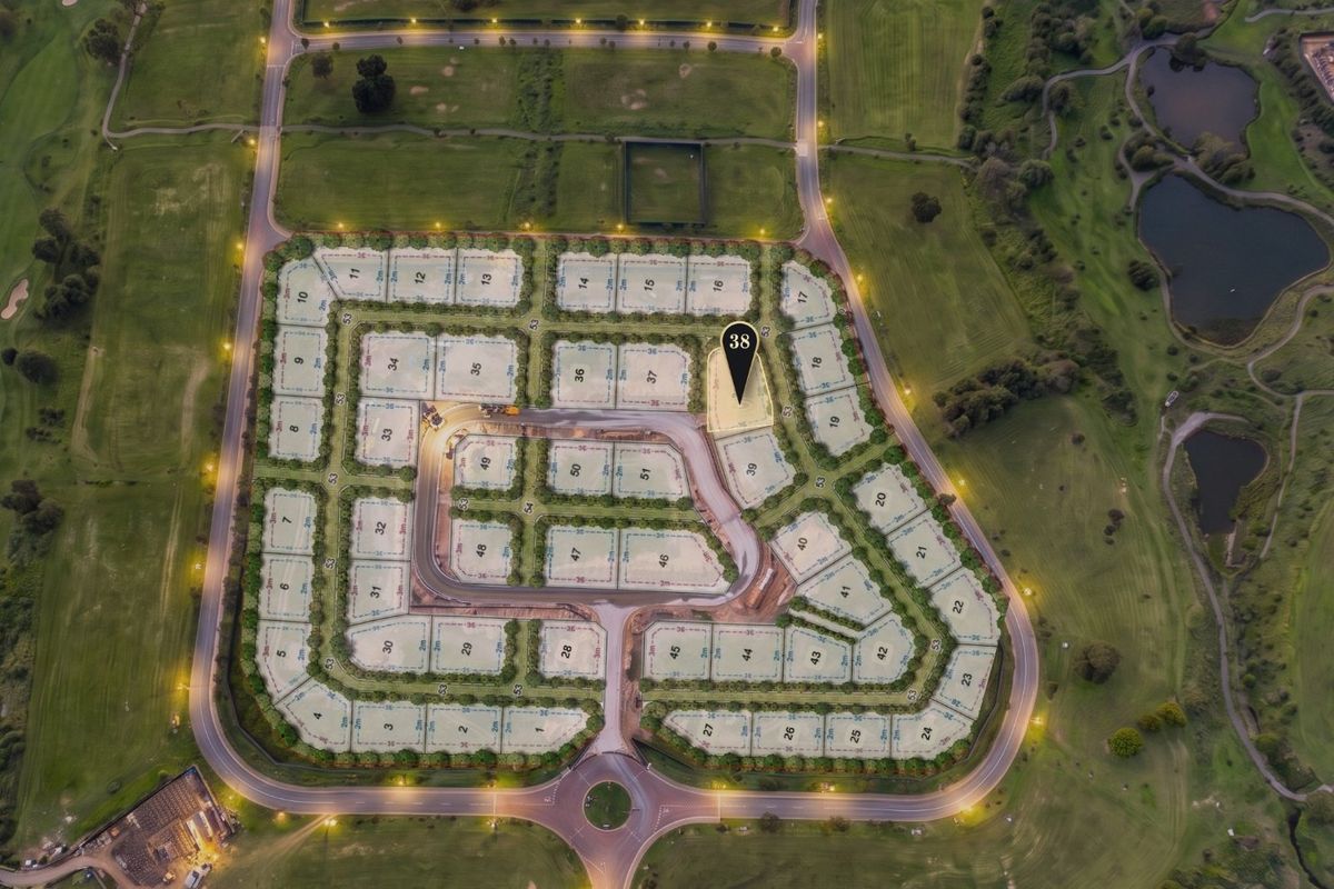 Aerial view of a residential estate development featuring numbered plots, paved internal roads, and street lighting, situated within a landscaped golf course environment.