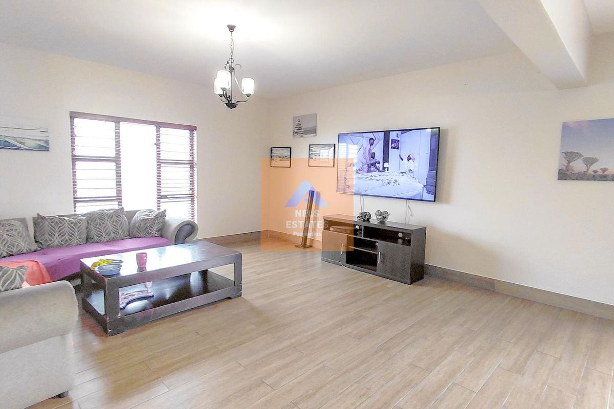 Spacious living room featuring wood-look tiled flooring, large windows with blinds, and a central light fixture.