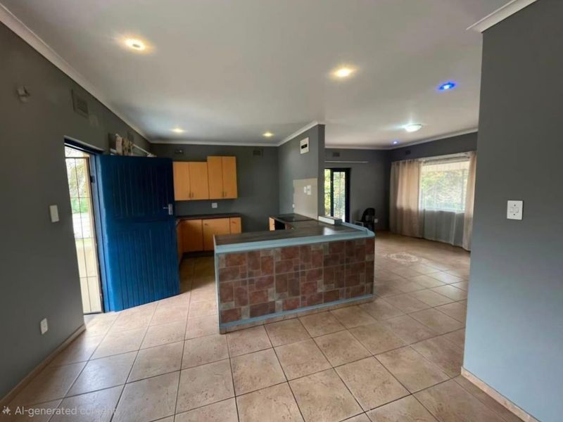 Open-plan living and kitchen area featuring tiled flooring, recessed lighting, and a breakfast bar with a tiled finish.