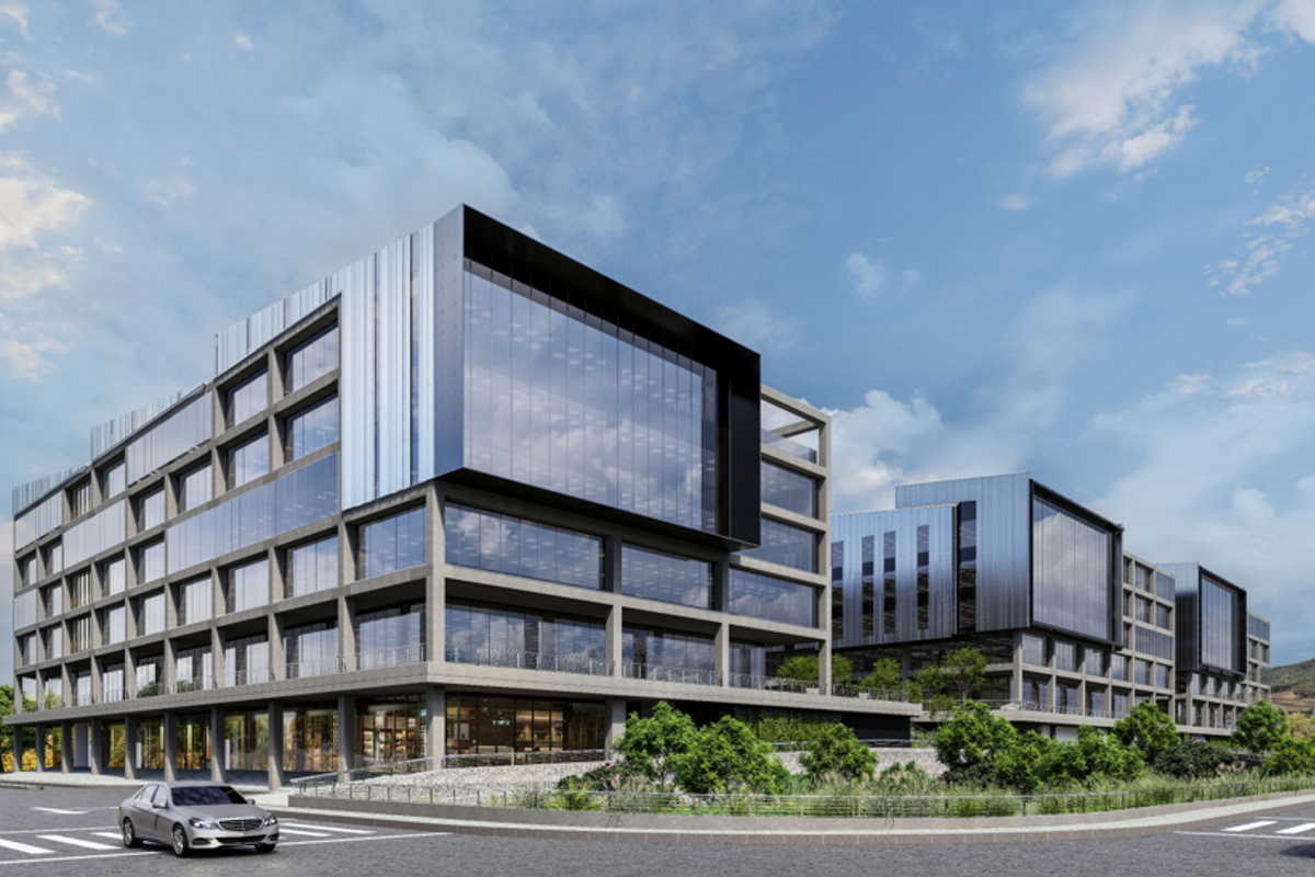Modern multi-story office complex featuring a contemporary glass and concrete facade with integrated landscaping and professional architectural design.