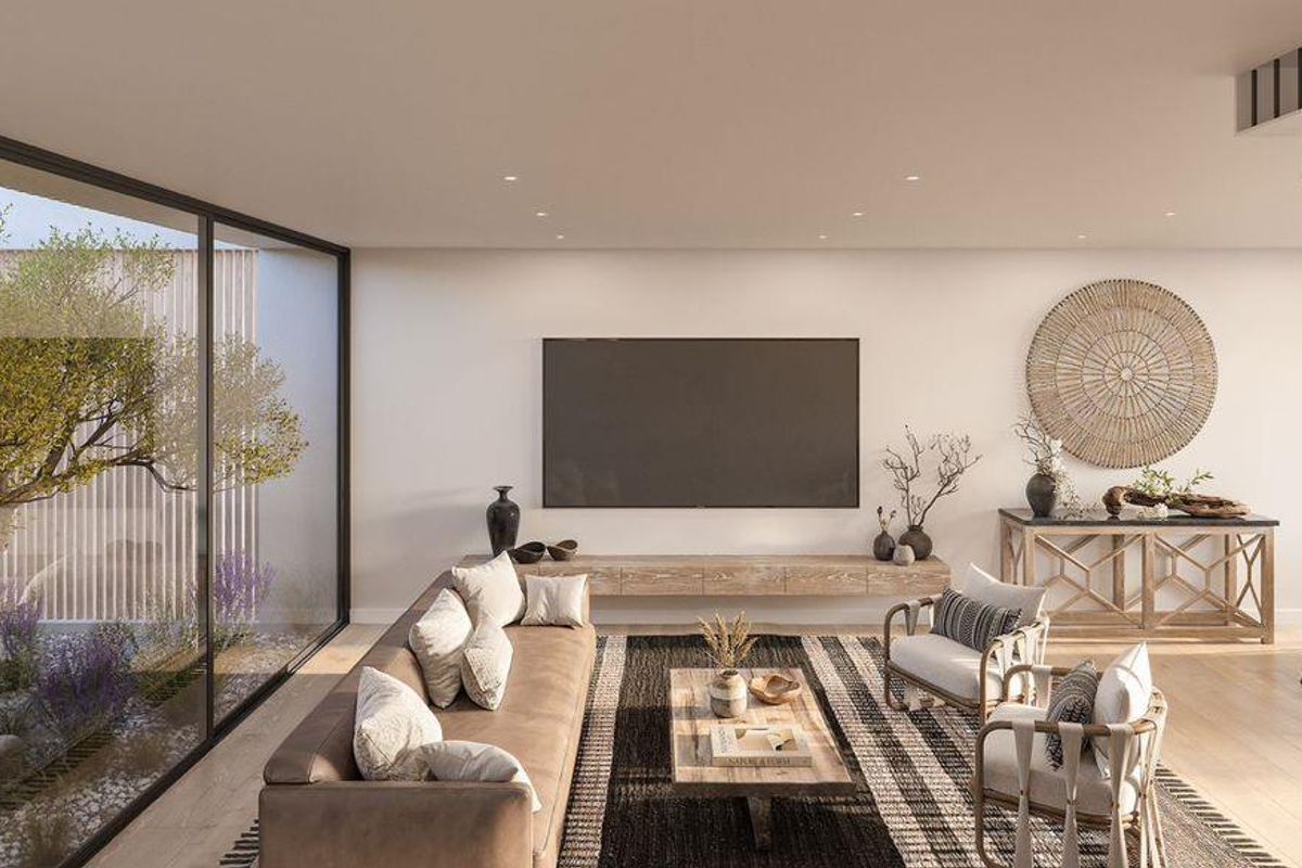 Spacious open-plan living area featuring large sliding glass doors, modern recessed lighting, a floating media console, and a contemporary staircase.