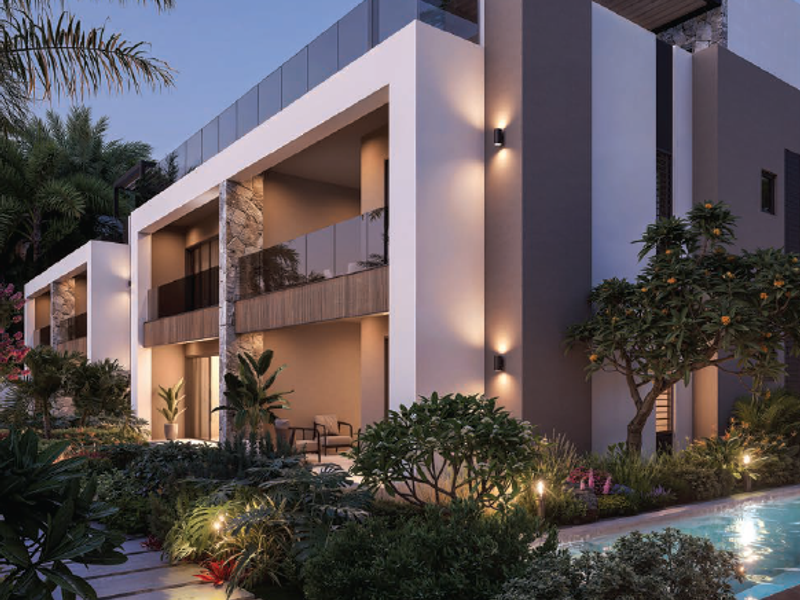 Modern penthouse exterior featuring multi-level balconies with glass balustrades, stone accents, and a beautifully landscaped pool area at dusk.
