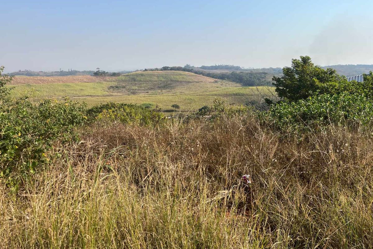 A scenic view overlooking rolling hills and natural landscape, showcasing the expansive terrain of the vacant residential land.