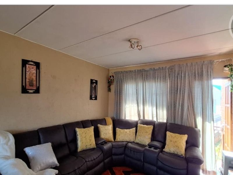 A living room area featuring a sliding glass door providing natural light and access to the exterior.