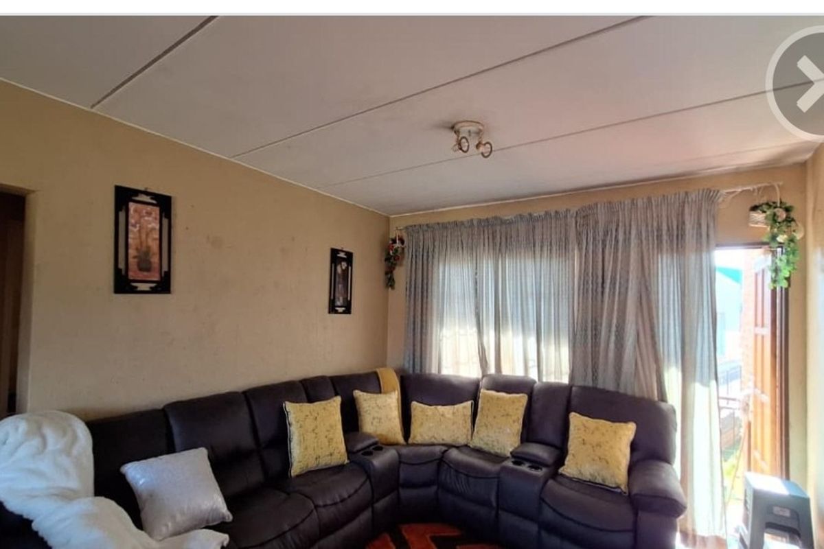 A living room area featuring a sliding glass door providing natural light and access to the exterior.