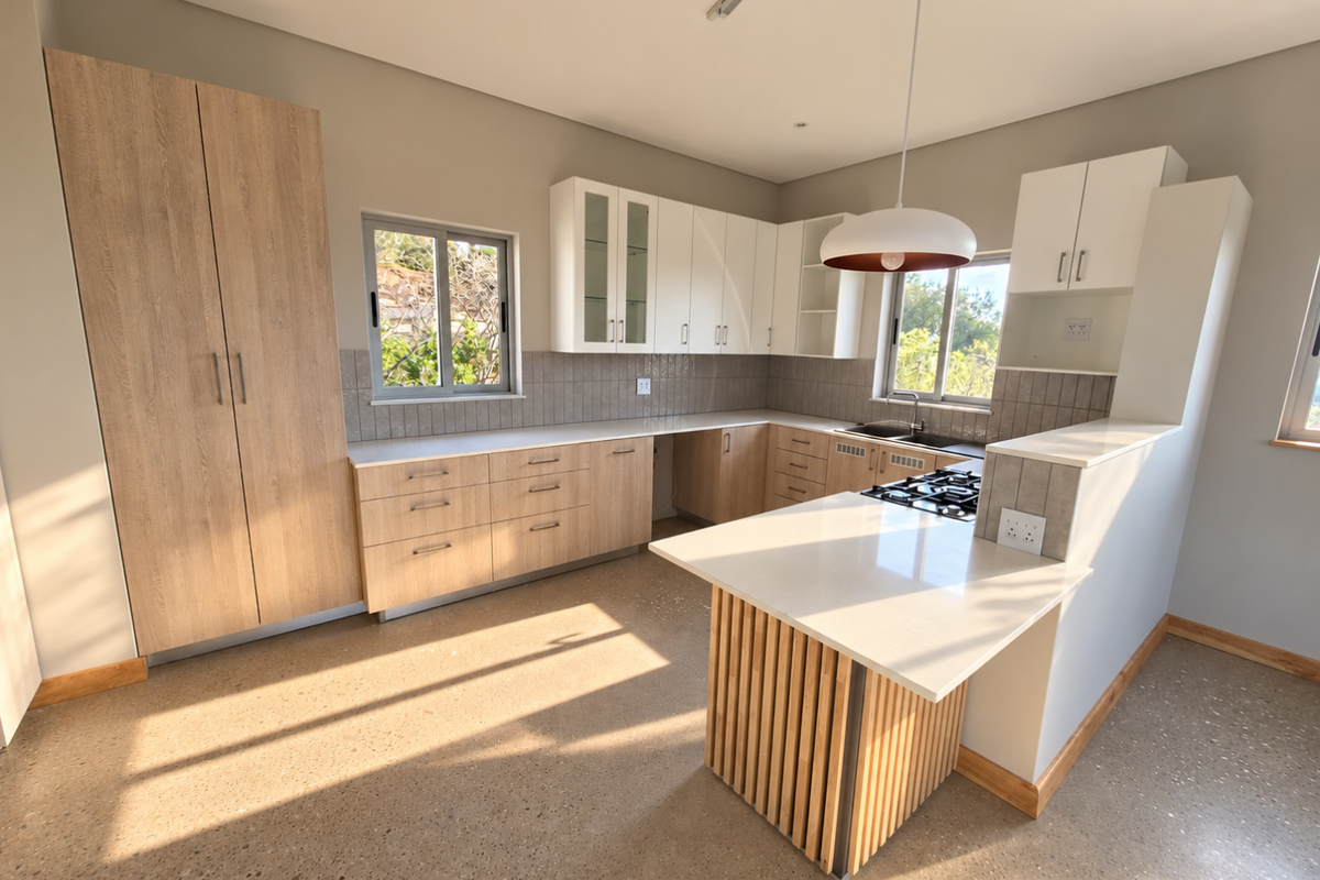 Modern kitchen featuring light wood and white cabinetry, stone countertops, a central island with a gas hob, and polished concrete floors.