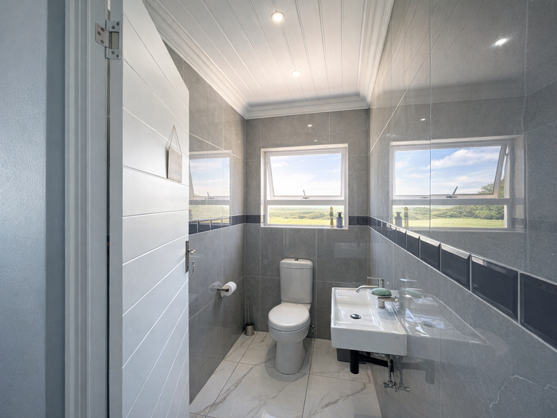 Modern Coastal Masterpiece: 3 Bedroom House with Flat - Photo 8