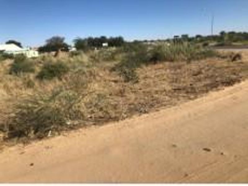 A view of an undeveloped commercial vacant land plot with direct access from a dirt road.