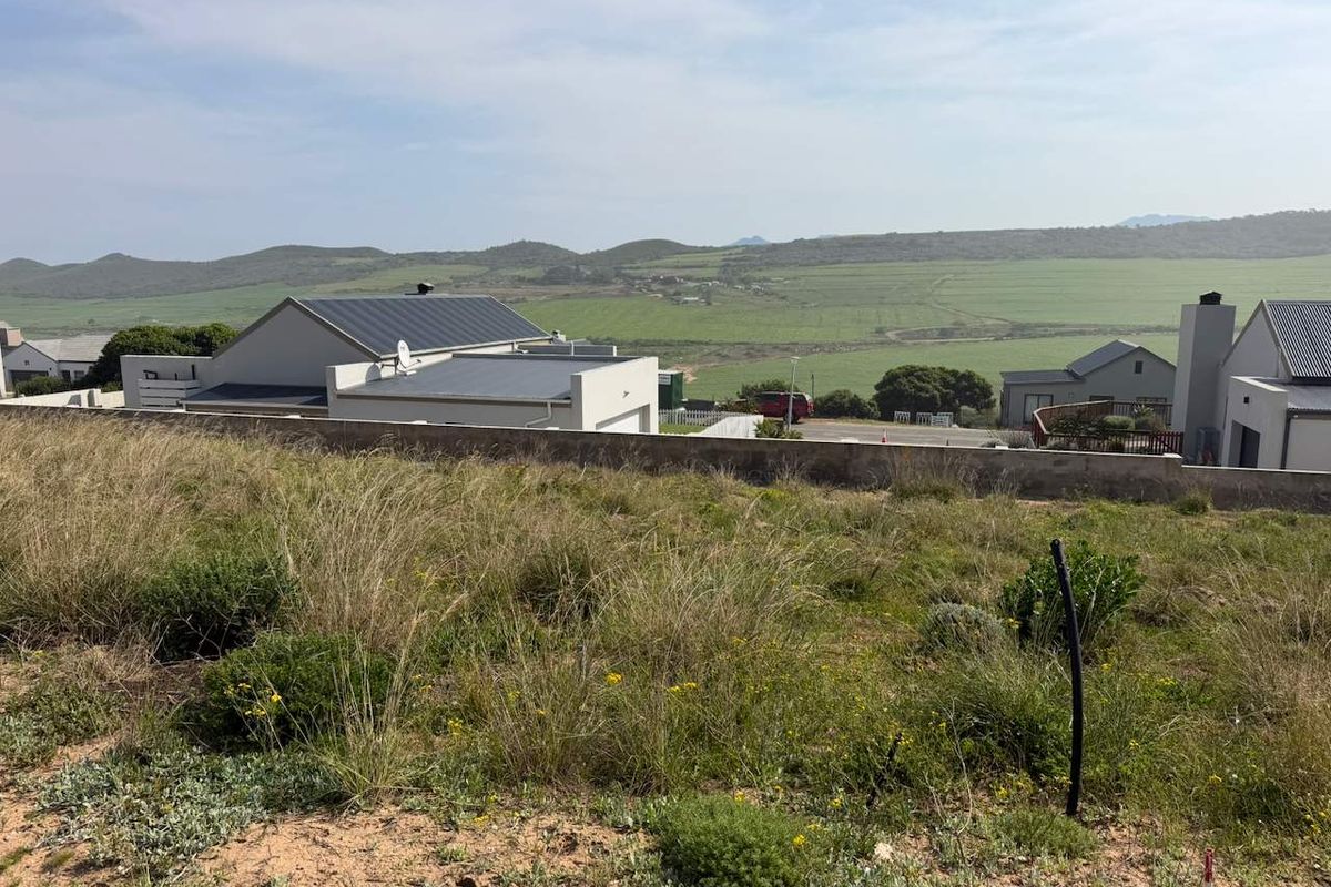 A view from the vacant residential plot overlooking the surrounding landscape and neighbouring properties.