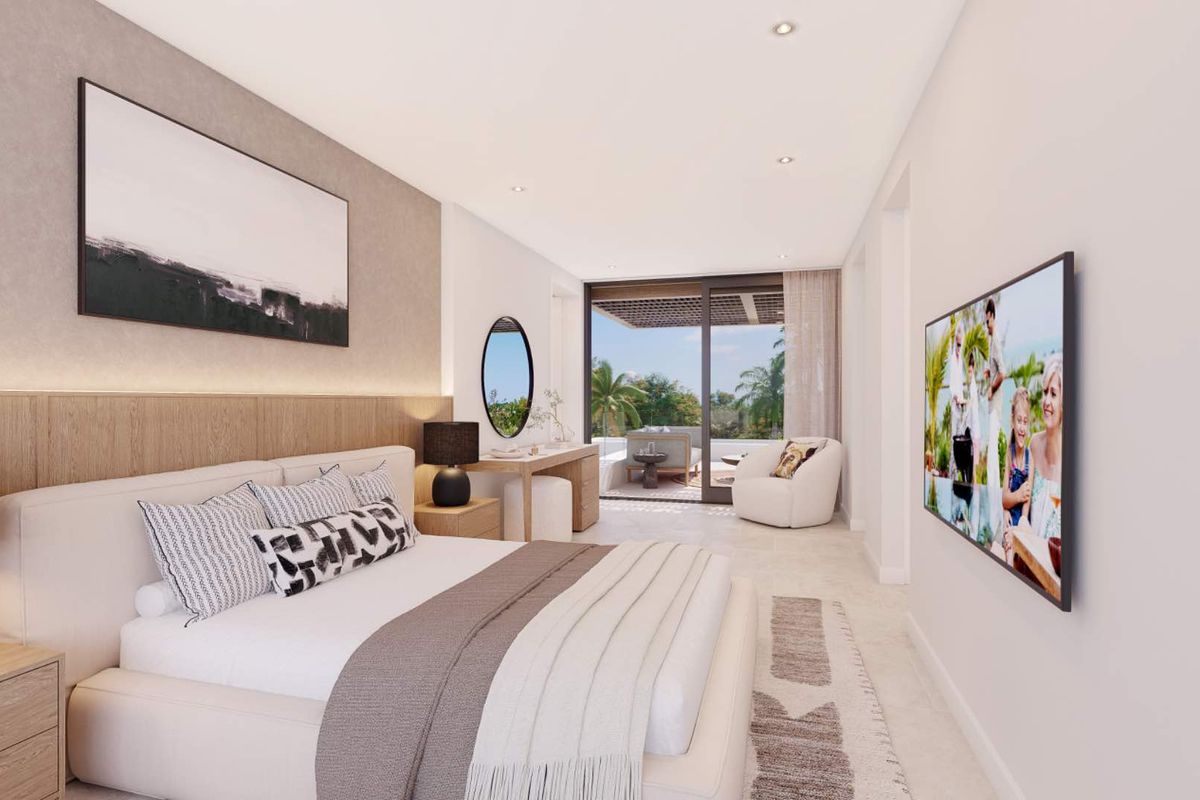 A modern, well-lit bedroom featuring integrated timber headboard paneling, recessed ceiling lighting, and large sliding glass doors opening onto a private patio.