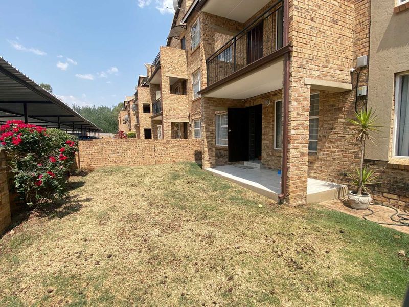 Ground floor apartment featuring a private garden and a covered patio with face brick exterior finishes.
