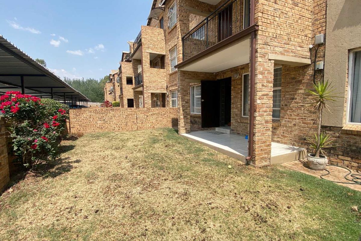Ground floor apartment featuring a private garden and a covered patio with face brick exterior finishes.