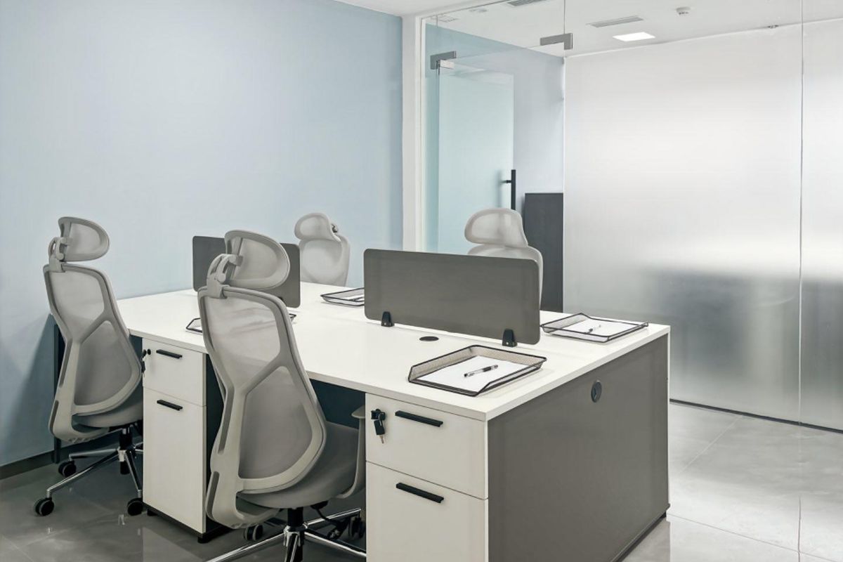 Modern office space featuring clean lines, recessed ceiling lighting, and a contemporary glass partition wall, creating a professional and bright work environment.