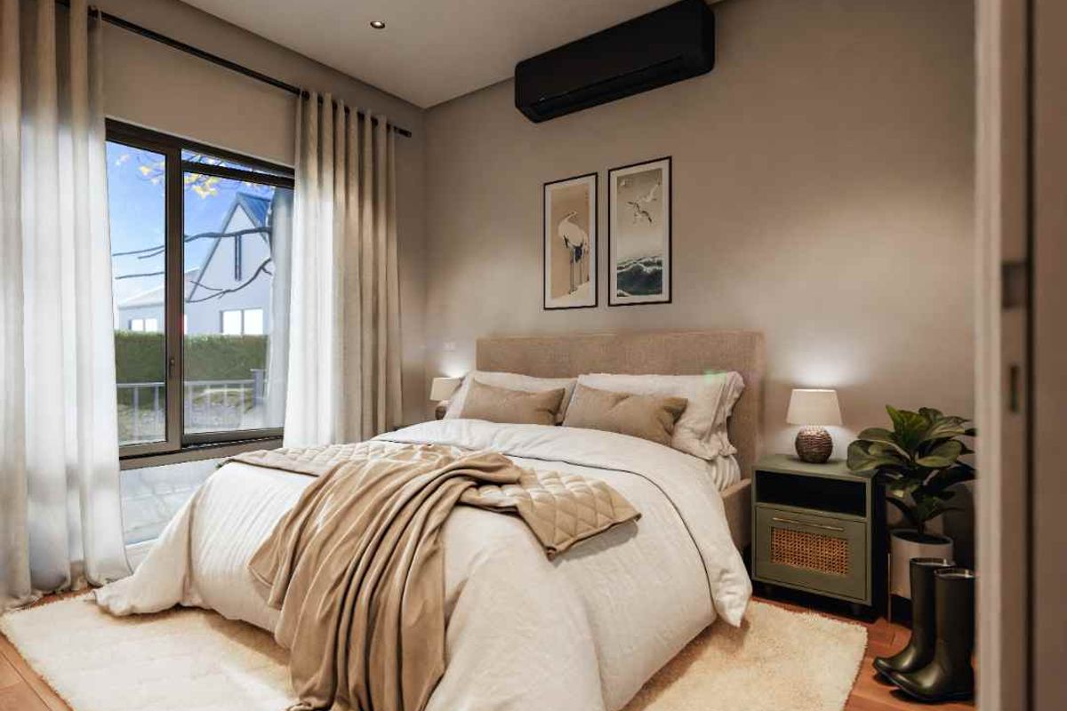 A well-appointed bedroom featuring modern timber flooring, recessed downlighting, and a wall-mounted air conditioning unit.