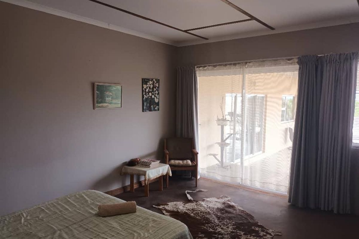 A bedroom featuring sliding glass doors that open to an outdoor patio area, providing natural light and access to the exterior.