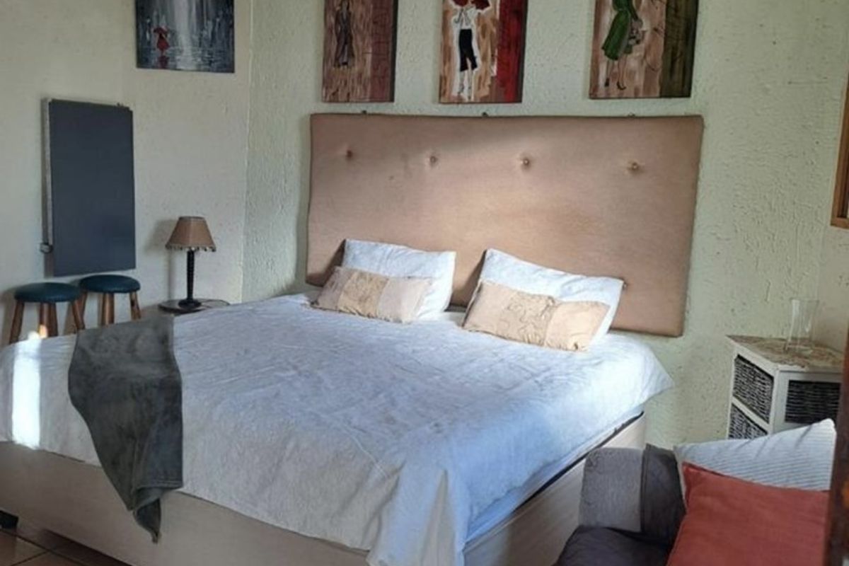 A bedroom featuring tiled flooring and a neutral wall finish, providing a functional space for rest.