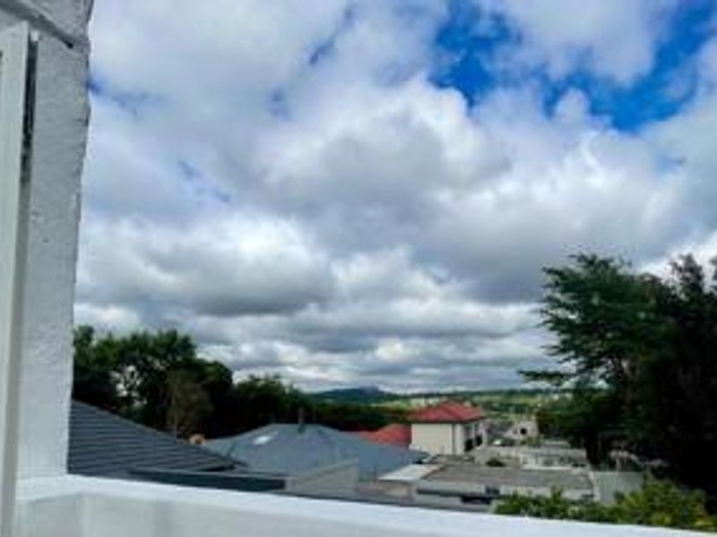 An elevated view overlooking the surrounding neighbourhood and distant landscape, captured from an upper level of the cottage.
