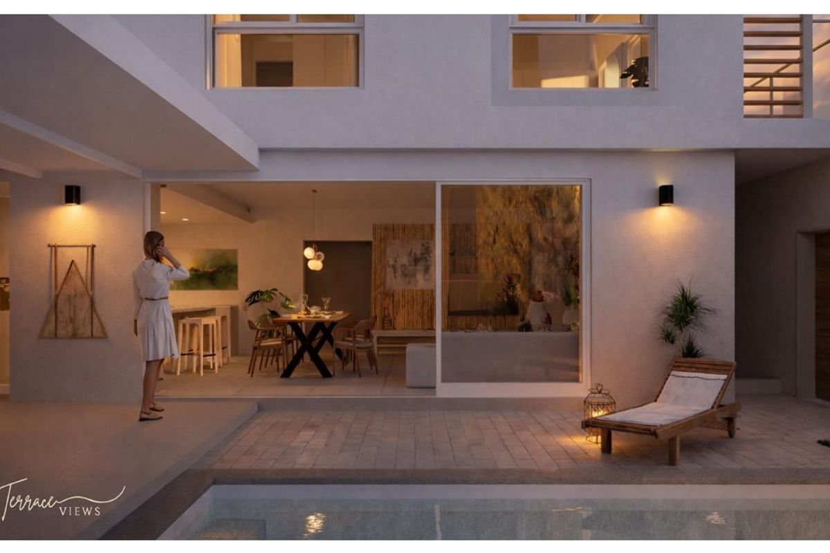 A modern townhouse exterior featuring a seamless transition between the indoor living area and the outdoor patio and pool deck at twilight.