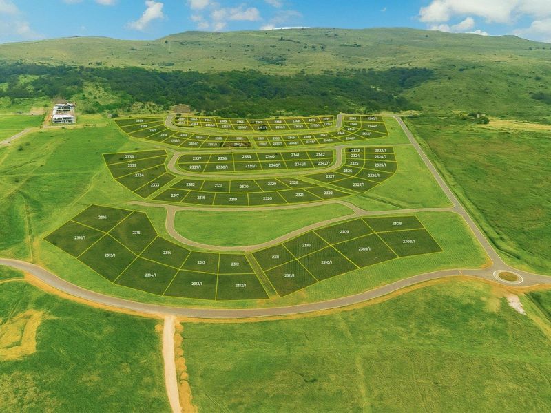Aerial view of a land development site showing subdivided plots and road infrastructure layout.