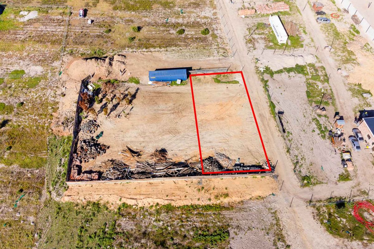 Aerial view of a vacant agricultural land plot, featuring cleared ground and perimeter fencing, suitable for development.
