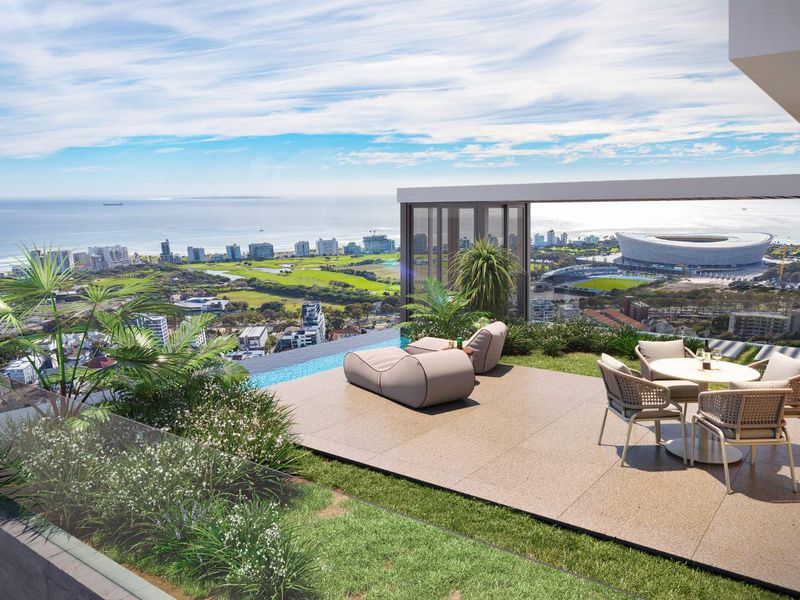 Expansive luxury balcony featuring an infinity pool, glass balustrades, and panoramic coastal and city views.