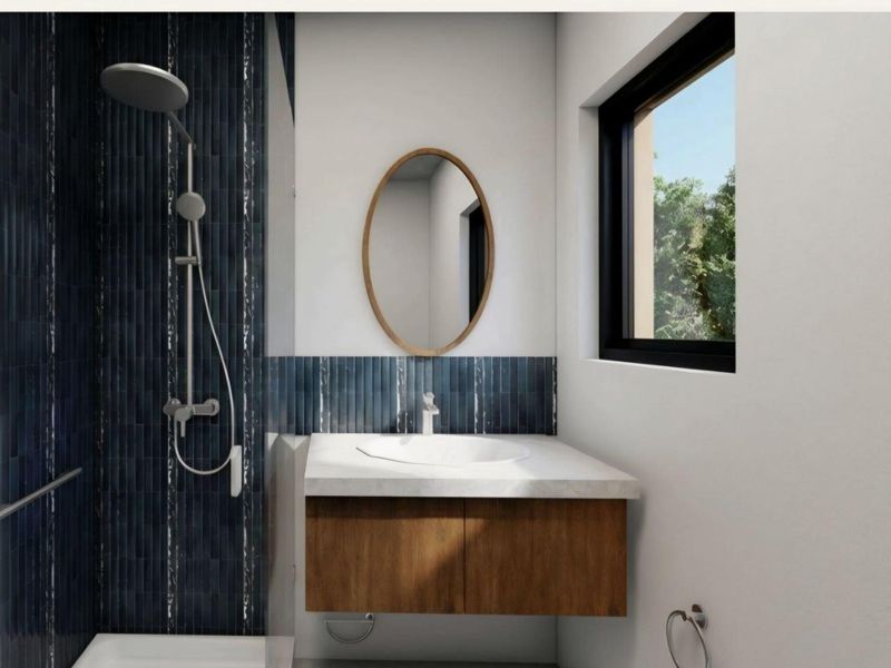 Modern bathroom featuring a wall-mounted vanity, integrated basin, and a stylish tiled shower area with contemporary fixtures.