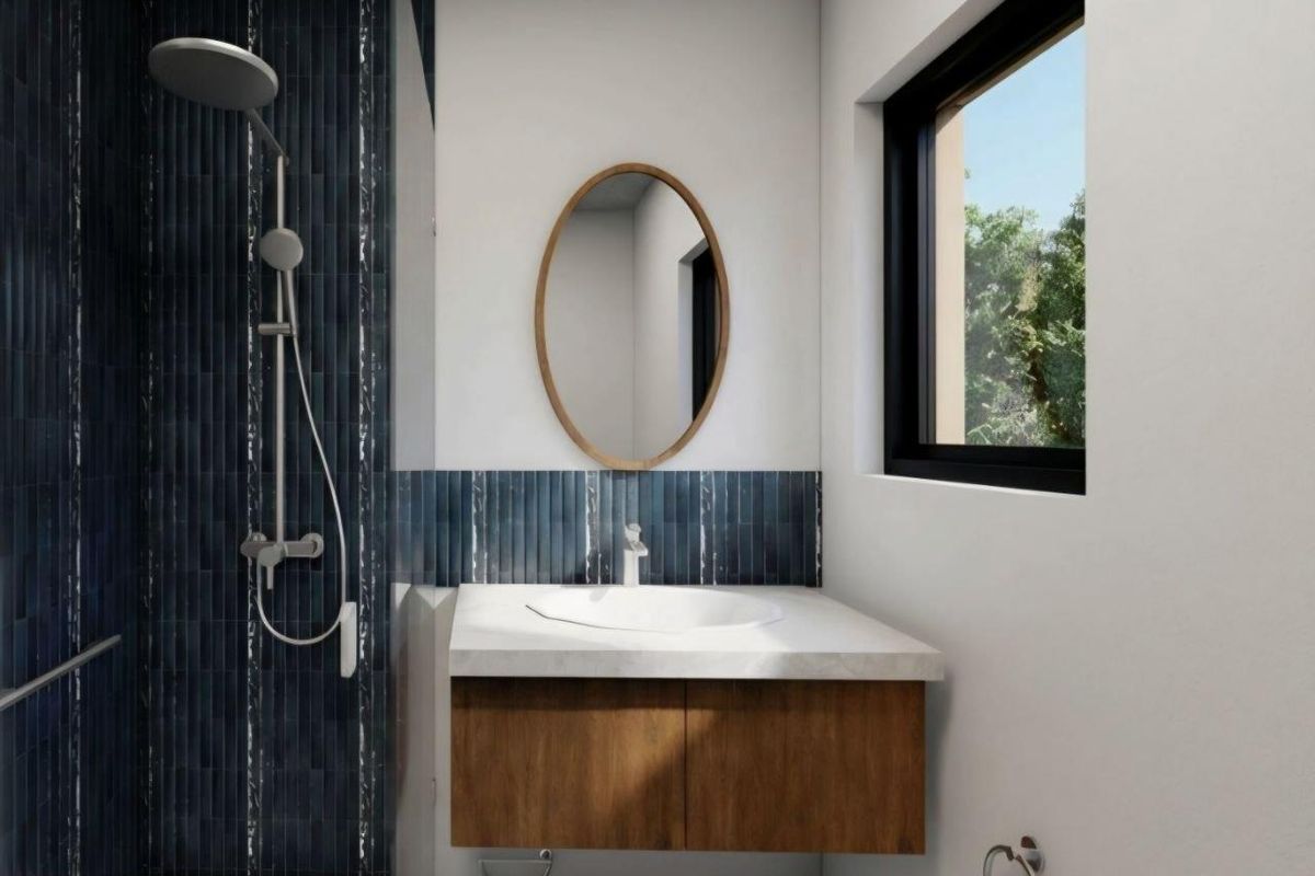 Modern bathroom featuring a wall-mounted vanity, integrated basin, and a stylish tiled shower area with contemporary fixtures.