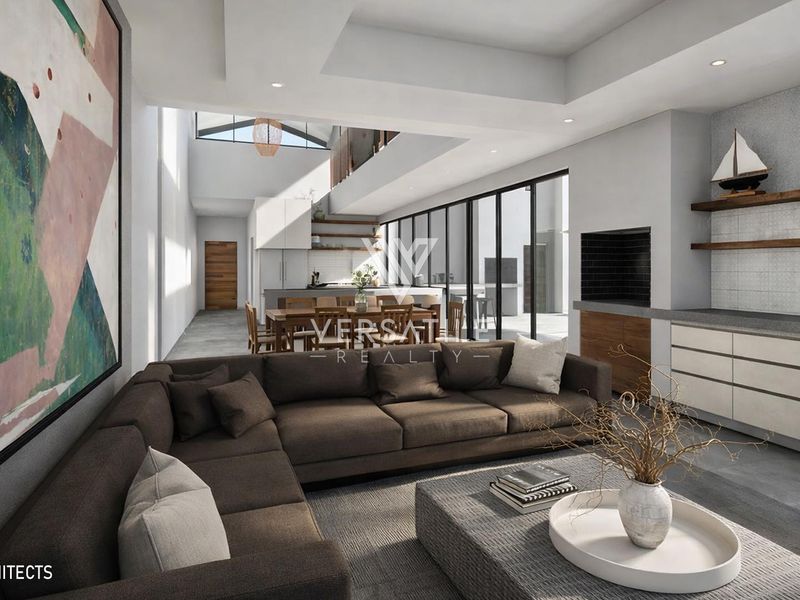 Modern open-plan living area featuring high ceilings, built-in fireplace, sleek cabinetry, and seamless flow to the kitchen and dining space.