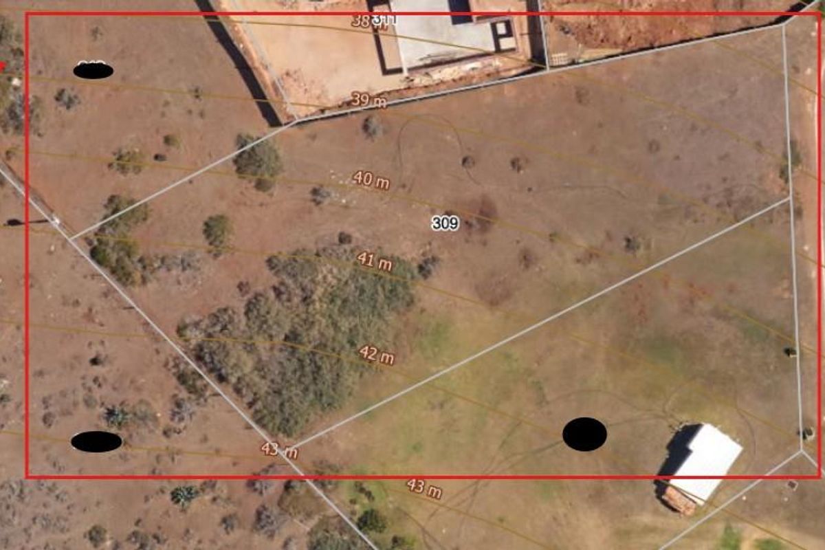 An aerial view of a vacant residential plot featuring topographical contour lines and boundary markers, suitable for future development.