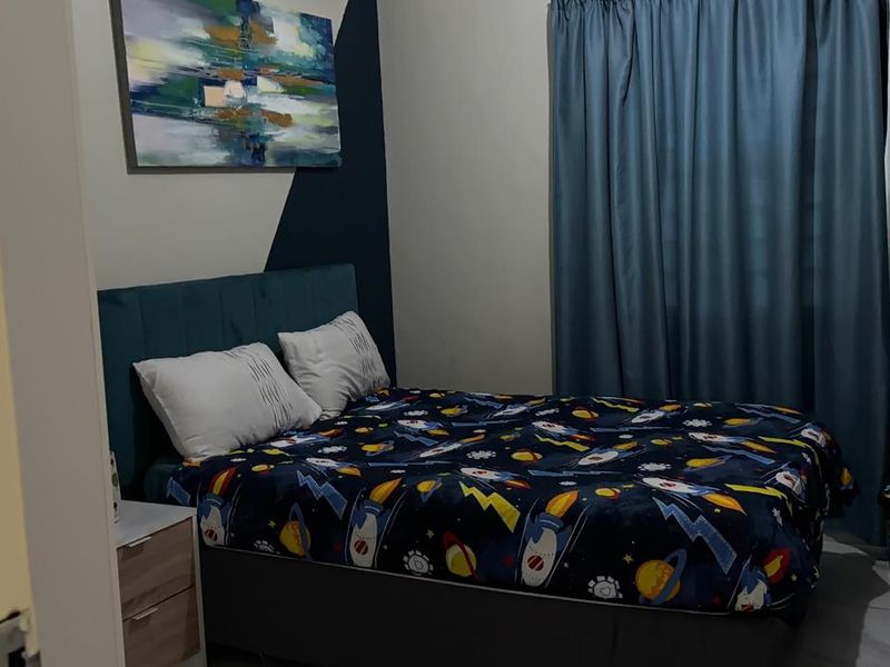 A cozy bedroom featuring tiled flooring and a decorative accent wall, providing a comfortable and functional sleeping space.
