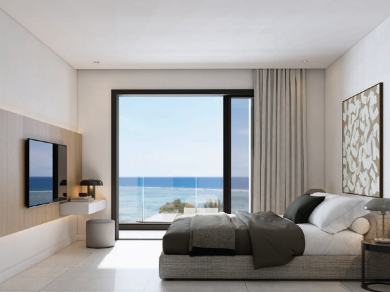 Modern bedroom featuring sleek tiled floors, built-in wall paneling, and a large sliding glass door offering expansive ocean views.