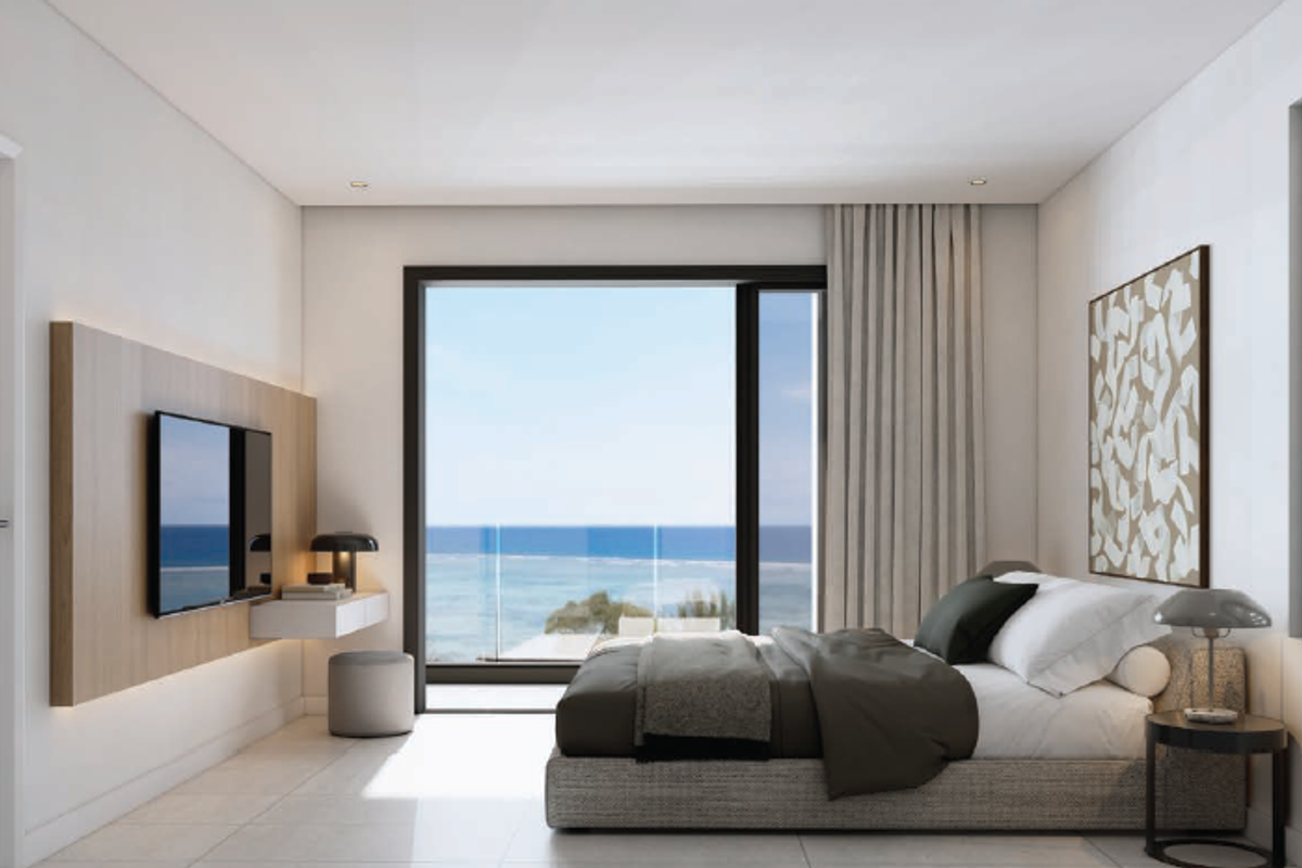 Modern bedroom featuring sleek tiled floors, built-in wall paneling, and a large sliding glass door offering expansive ocean views.