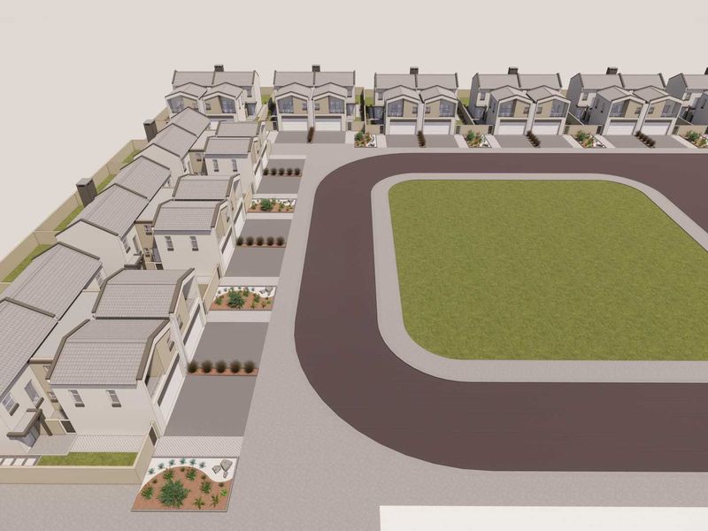 An aerial view of a townhouse complex featuring multiple units with tiled roofs, paved driveways, and a central communal lawn area.