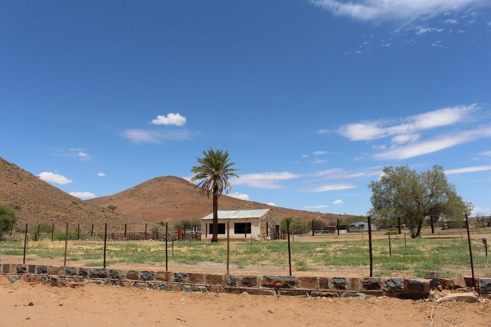 Hill tops and farm buildings surrounded by fencing