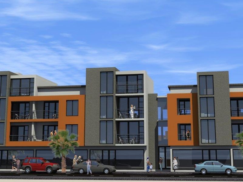 A modern multi-story apartment building featuring contemporary facade design, private balconies, and ground-floor commercial space.