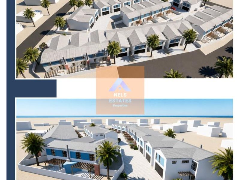 Aerial perspective of a modern townhouse development featuring multiple units, paved access roads, and landscaped grounds.