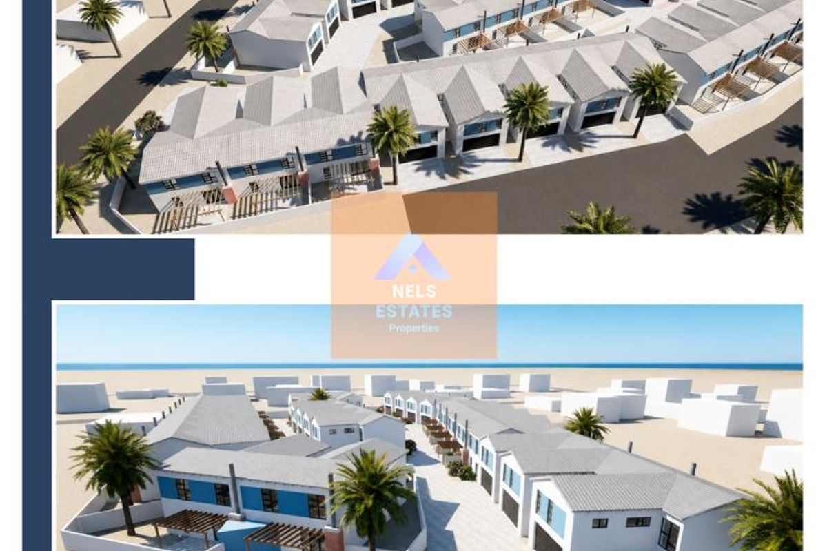 Aerial perspective of a modern townhouse development featuring multiple units, paved access roads, and landscaped grounds.