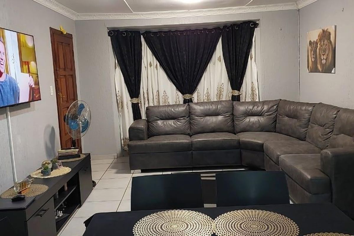 A living room featuring tiled flooring and coved ceiling details, providing a functional space for relaxation and entertainment.
