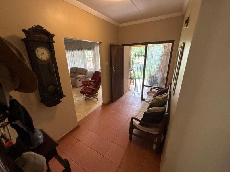 Entrance hall featuring tiled flooring and direct access to the living area, providing a functional transition space within the home.