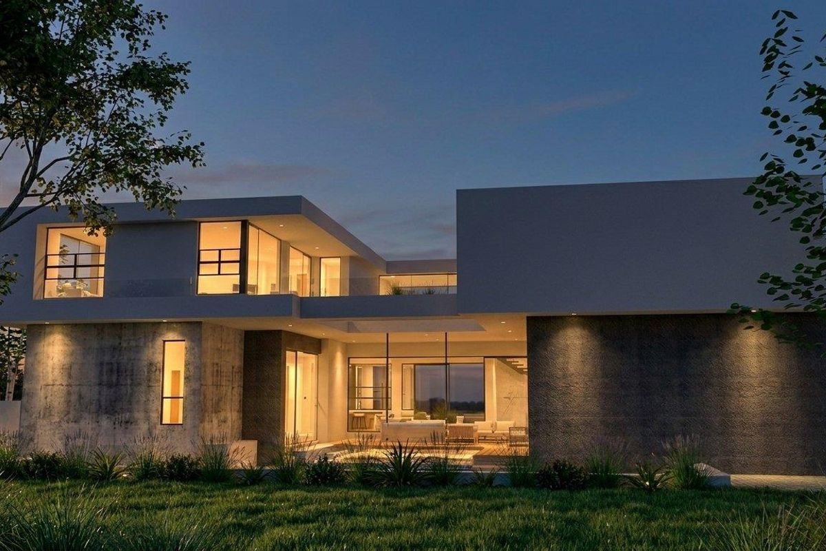 A modern architectural luxury home featuring a concrete facade, expansive glass windows, and integrated outdoor lighting at dusk.