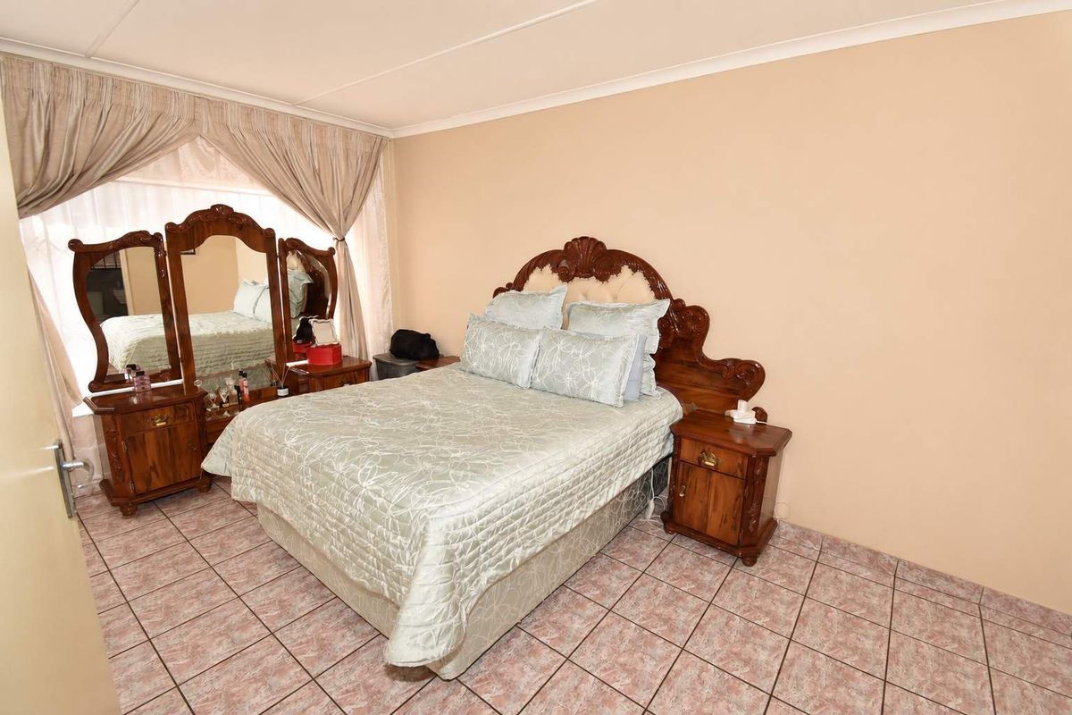 A bedroom featuring tiled flooring and coved ceilings, offering a functional space ready for modern updates.