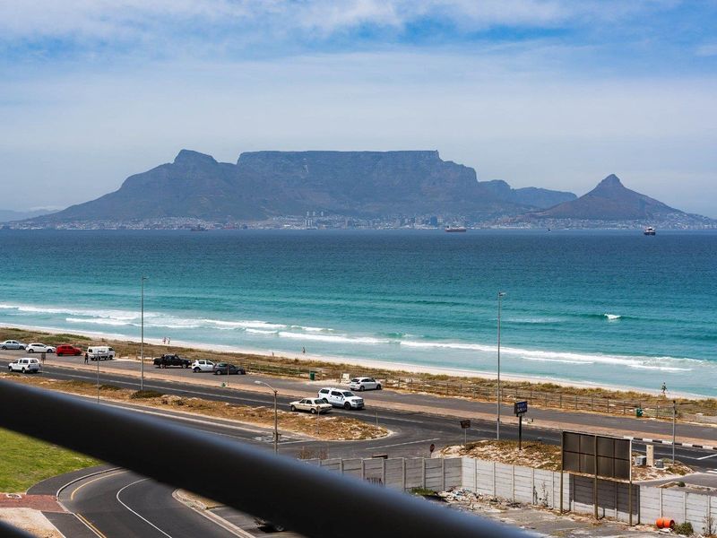 Stunning panoramic view of the ocean and Table Mountain, captured from an elevated apartment balcony.