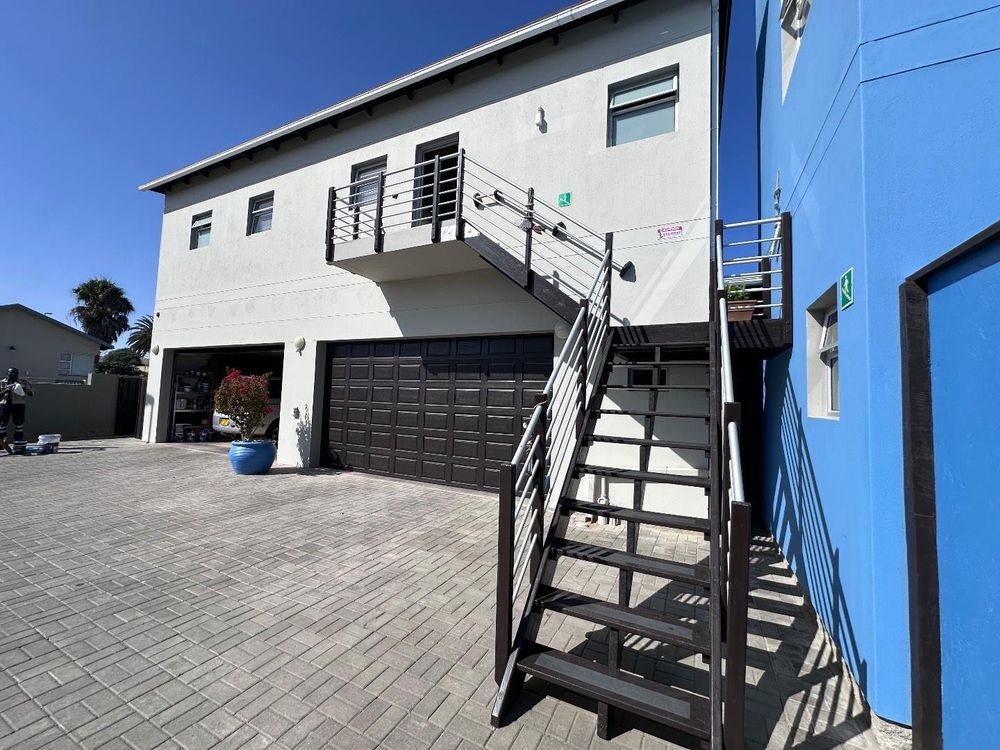Homes Double Garage leading to Main Flat - 2 ensuite bedrooms, open plan kitchen with lounge and inside barbecue and balcony.